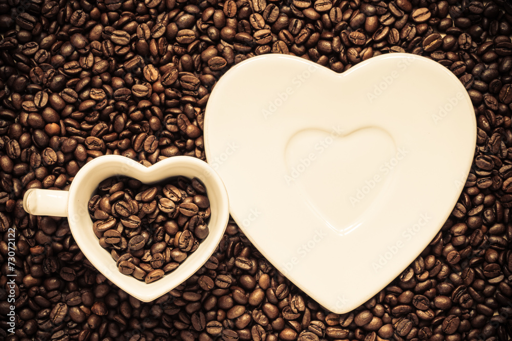 cup and saucer on coffee beans background