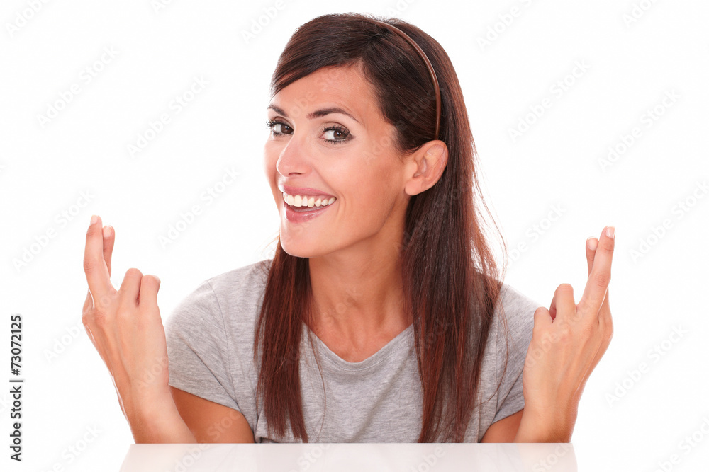 Attractive lady crossing her fingers while smiling Attractive lady crossing her fingers while smiling