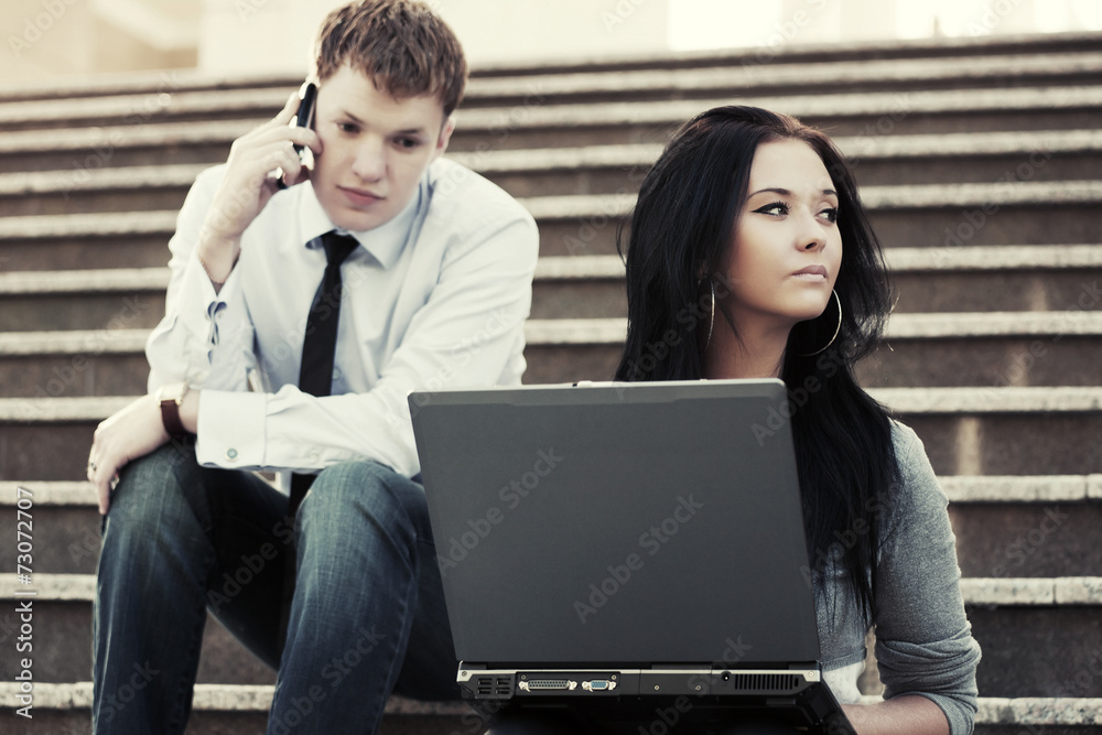 Young business couple using laptop outdoor Young business couple using laptop outdoor