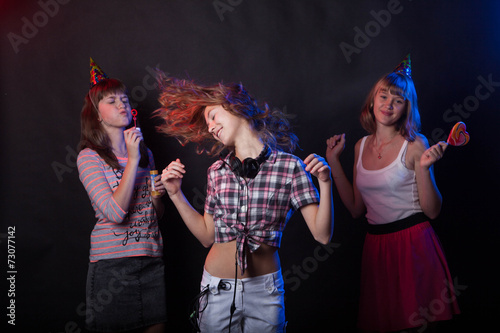 teenage girls having fun and dancing at a party