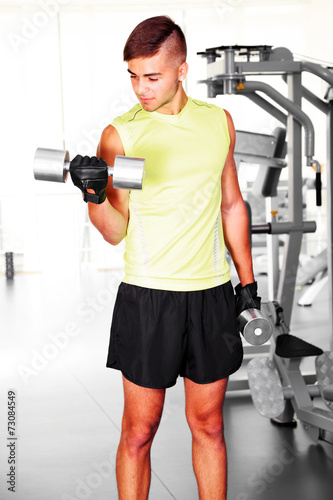 Guy with dumbbells in gym