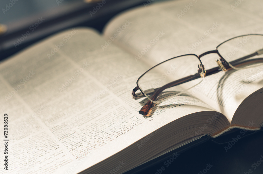picture a pile of books and eyeglasses, with retro effect picture a pile of books and eyeglasses, with retro effect