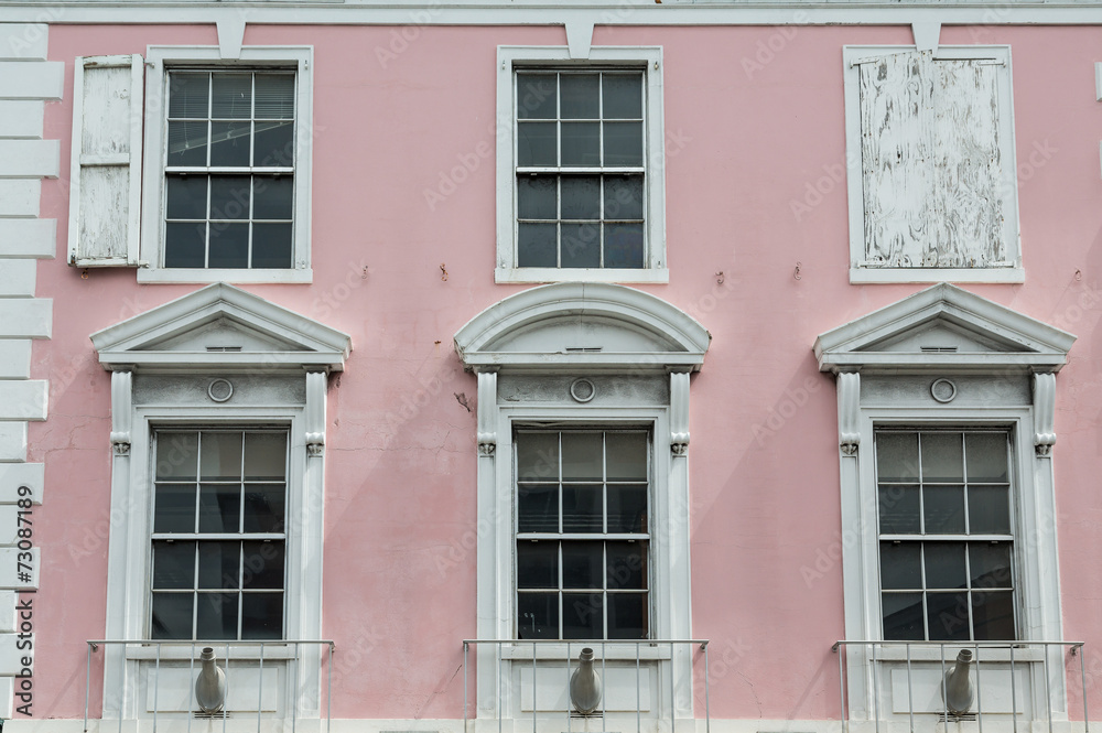 White Windows on Old Pink Government Building in Bahamas