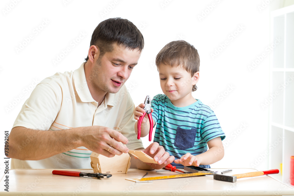 Dad and son child working with tools together Dad and son child working with tools together