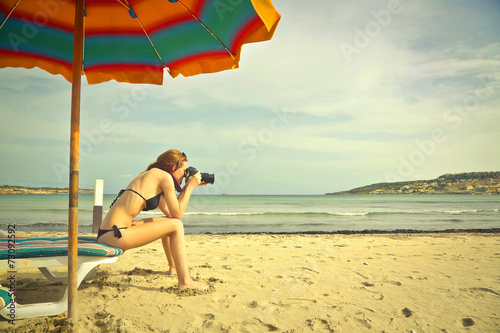 Girl using a binoculars at the seaside © olly