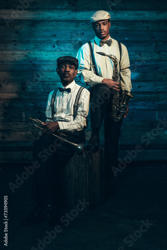 Two african american jazz musicians with trumpet and saxophone s