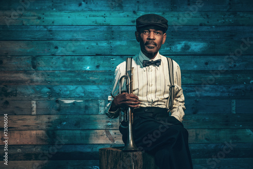 Vintage african american senior jazz musician with trumpet in fr