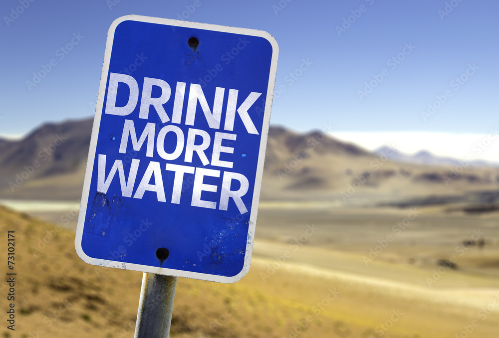 Drink More Water sign with a desert background Drink More Water sign with a desert background