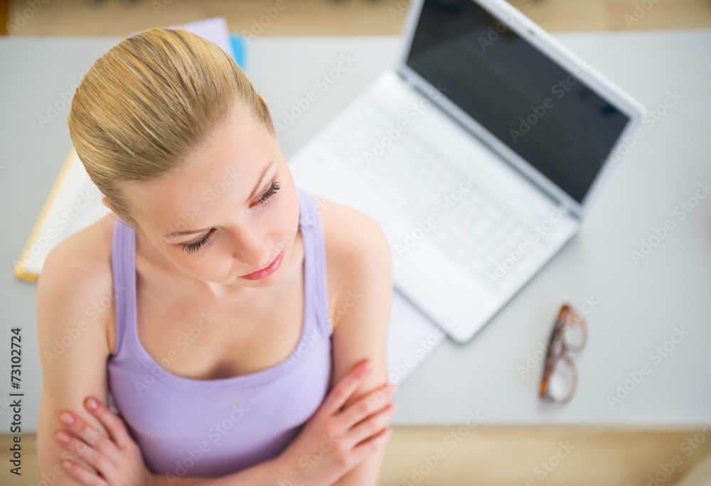 Thoughtful young woman studying in kitchen Thoughtful young woman studying in kitchen
