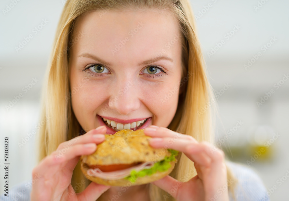 Portrait of happy young woman eating sandwich Portrait of happy young woman eating sandwich