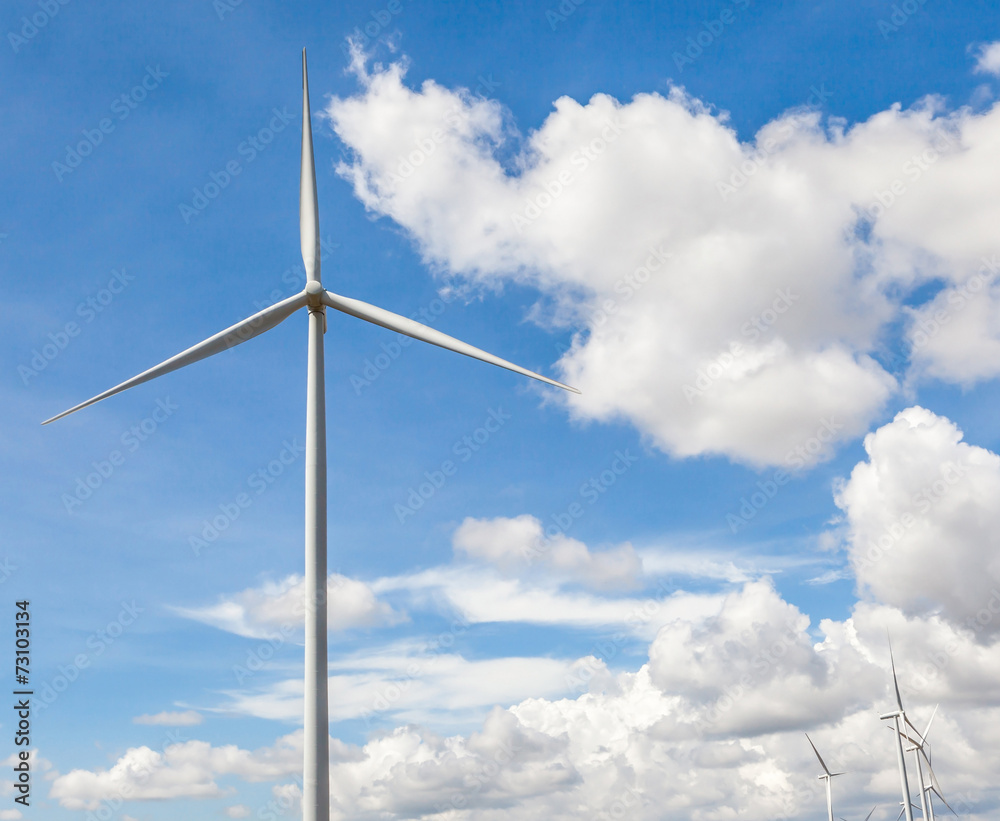The wind turbine in beautiful cloudy blue sky background in wind The wind turbine in beautiful cloudy blue sky background in wind