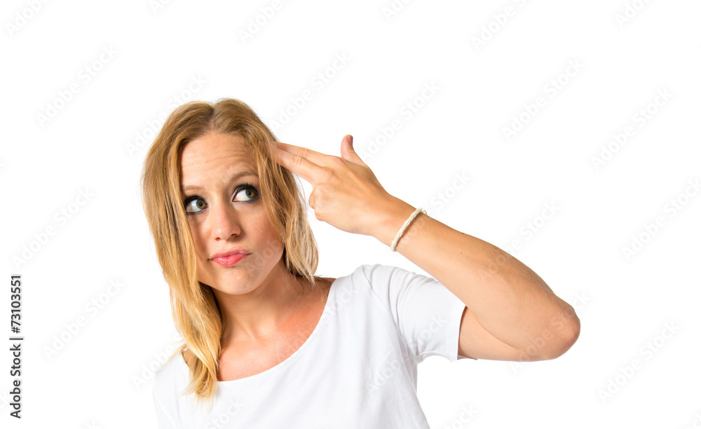 Girl making suicide gesture over white background Girl making suicide gesture over white background