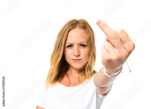 Girl making horn gesture over white background