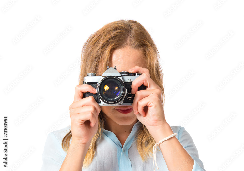 Blonde woman photographing over white background Blonde woman photographing over white background