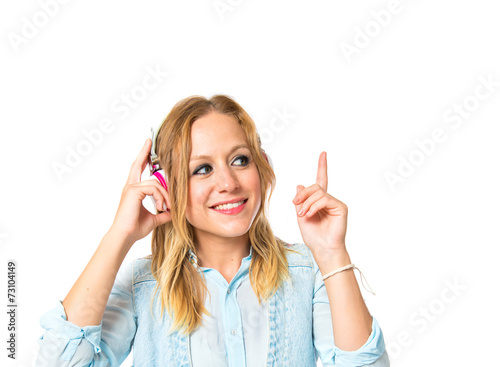 Young woman listening music over white background