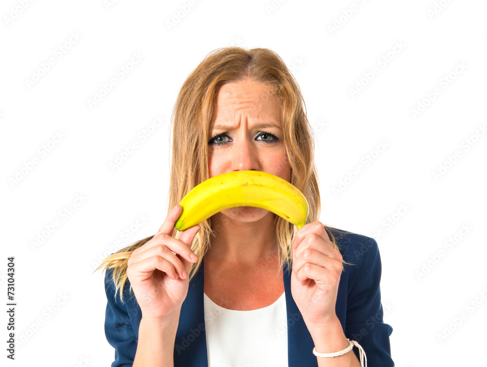Blonde girl with banana as mouth over white background Blonde girl with banana as mouth over white background