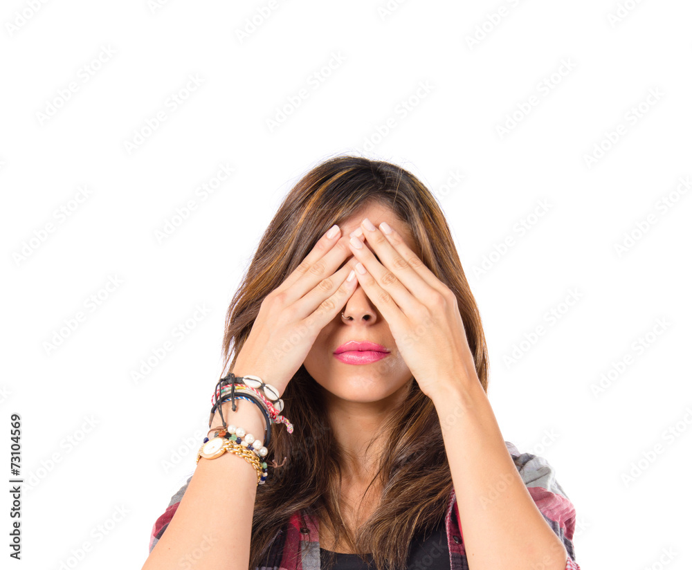 Girl covering her eyes over isolated white background Girl covering her eyes over isolated white background
