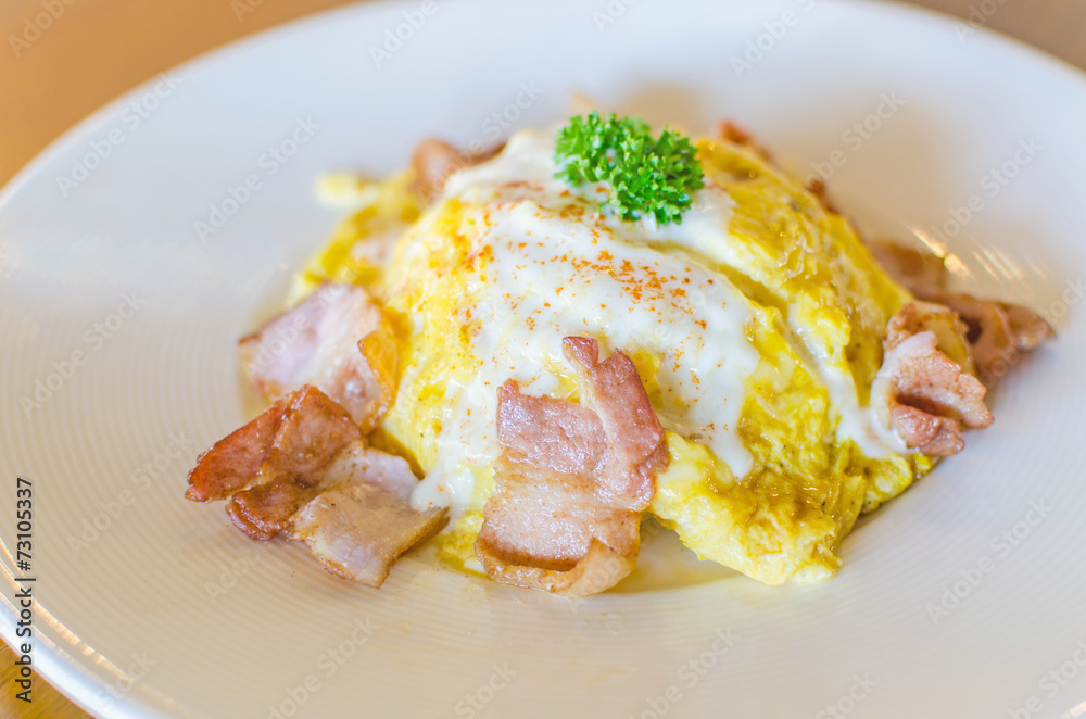 omelet and bacon on white plate. omelet and bacon on white plate.