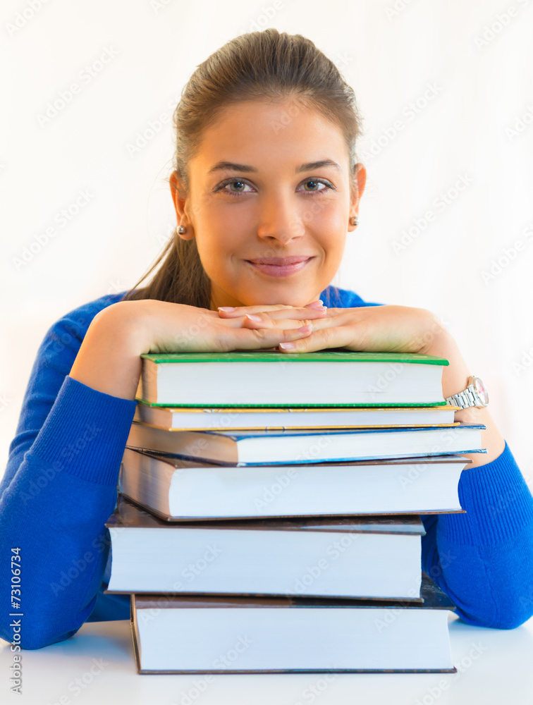 Smiling student with stack of books Smiling student with stack of books