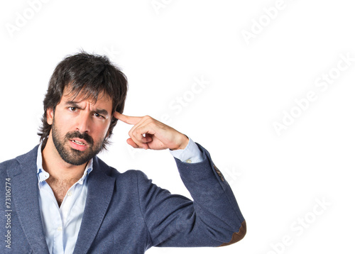 Man making suicide gesture over white background