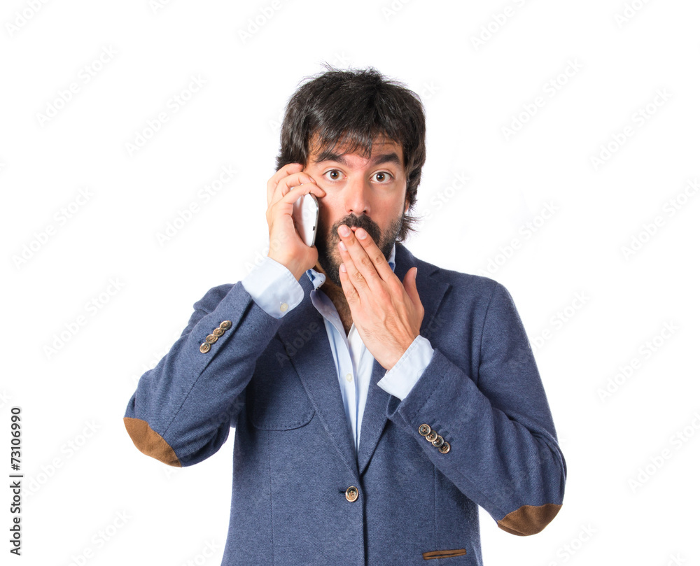 Brunetteman talking to mobile over white background Brunetteman talking to mobile over white background