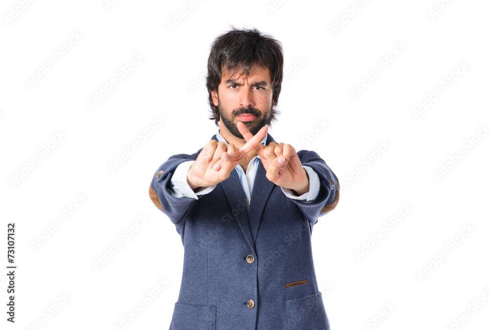 Handsome man doing NO gesture over white background Handsome man doing NO gesture over white background