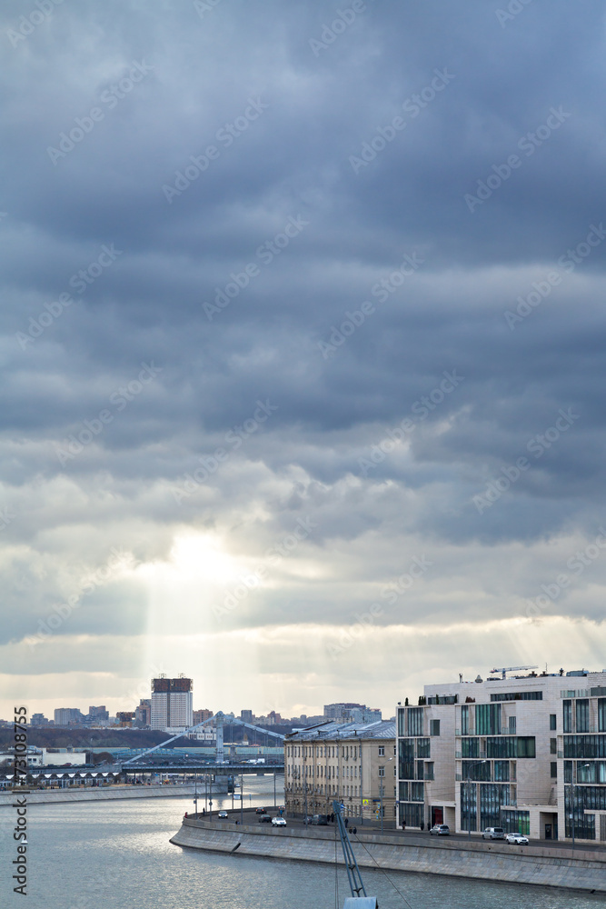 dark rainy clouds and sunbeams over Moscow city