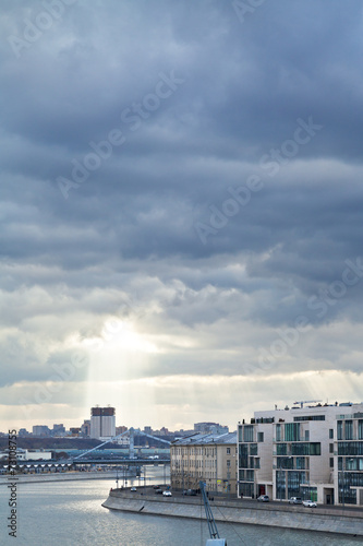 dark rainy clouds and sunbeams over Moscow city © vvoe