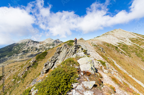 Fototapeta Naklejka Na Ścianę i Meble -  Backpacker standing mountain ridge.