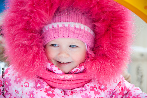 Wallpaper Mural Funny cute baby girl with big blue eyes wearing a huge winter hat and a warm knitted jacket Torontodigital.ca