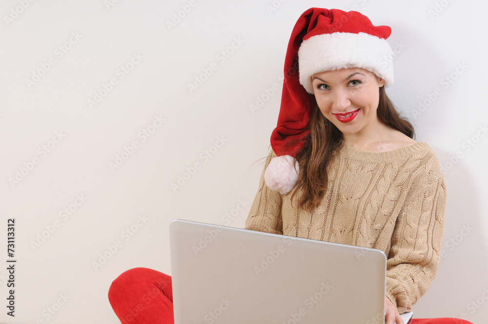 beautiful young woman in santa hat sitting on the floor with not beautiful young woman in santa hat sitting on the floor with not