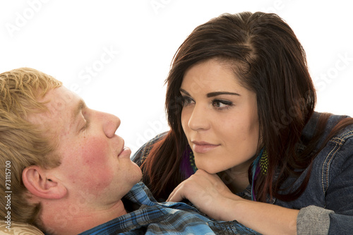 man lay on back woman look at him hand under chin