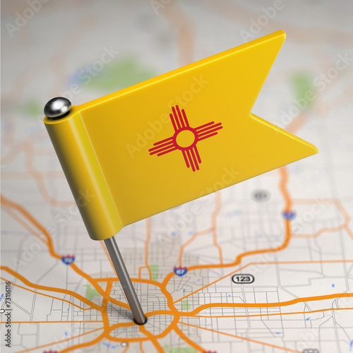 New Mexico Small Flag on a Map Background. photo