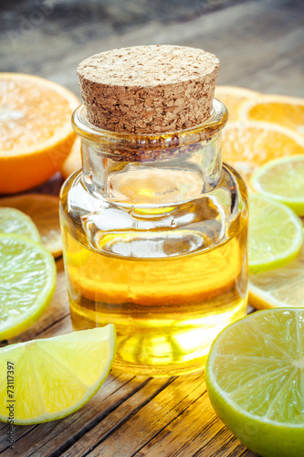 citrus essential oil and slice of orange, lemon and lime fruits