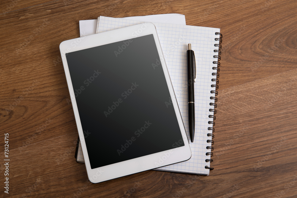 digital tablet on a wooden background digital tablet on a wooden background