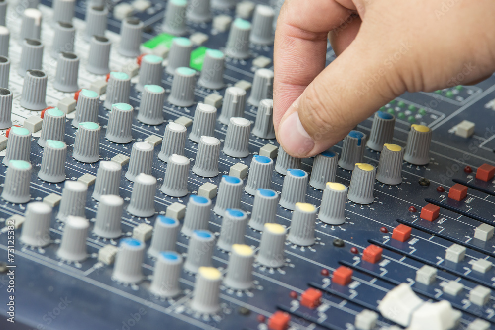 Fototapeta premium An expert adjusting audio mixing console