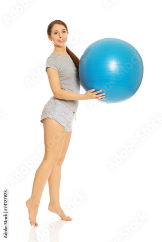 Woman holding fitness ball