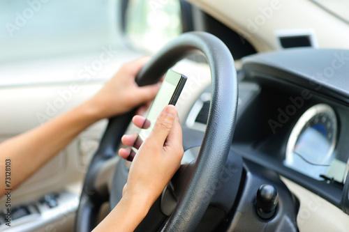 woman driver hands use cellphone driving a car