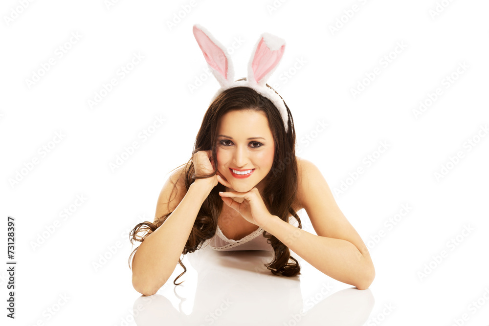 Portrait of lying woman wearing bunny ears