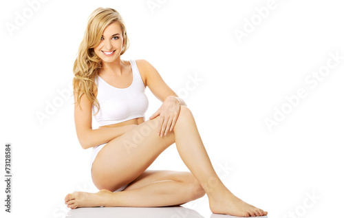 Woman in underwear sitting on the floor