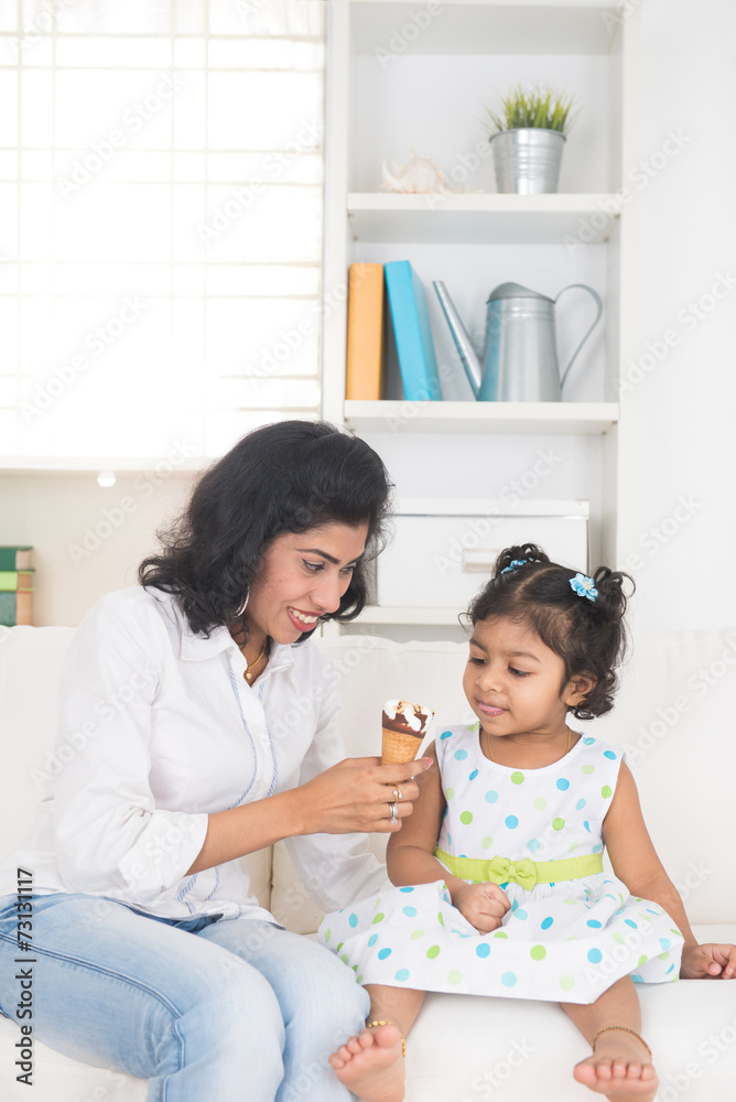 indian mother and child enjoying ice cream indoor indian mother and child enjoying ice cream indoor