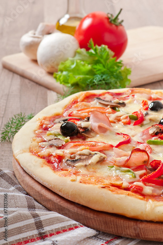 Pizza with ham, mushrooms and olives