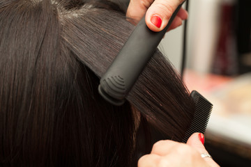 Handdoek met foto Kapsalon Haarstyling met stijltang in detail  © CorinaDanielaObertas
