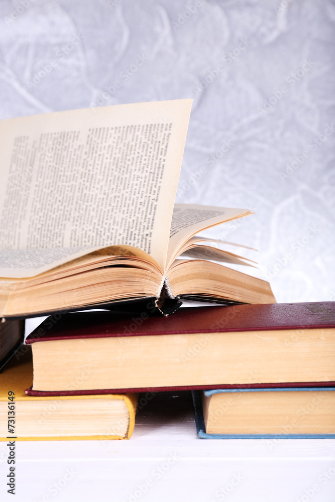 Books on wooden table on light background Books on wooden table on light background