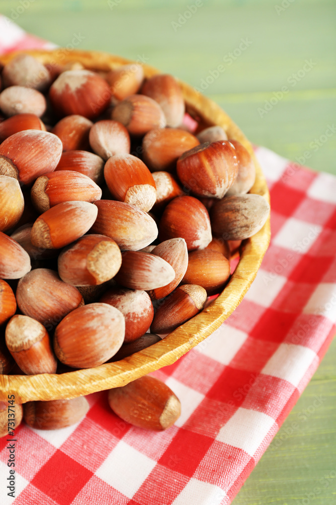 Hazelnuts on wicker mat on wooden background Hazelnuts on wicker mat on wooden background