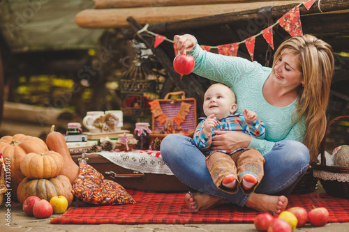 Mother and son playing in the yard of his house in the village photo