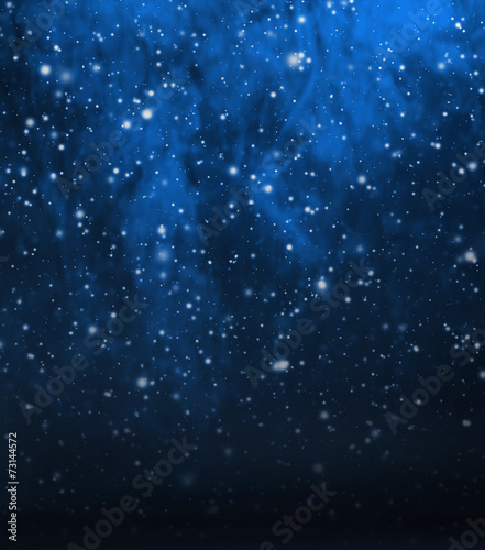 Deep blue Christmas background with falling snow