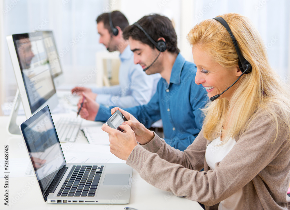 Young attractive woman sending text at work Young attractive woman sending text at work