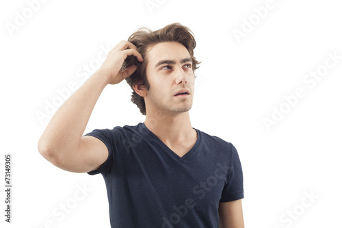 Young man scratching his head