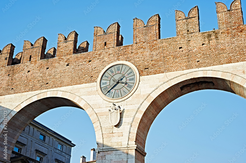 The city wall with a clock in Verona